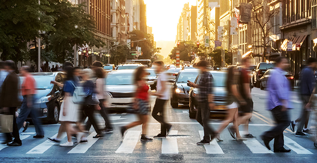 A group of people cross a busy intersection