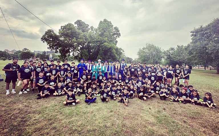 Puede Network founder Adan Gonzalez and the children his nonprofit serves in the South Oak Cliff neighborhood in Dallas.